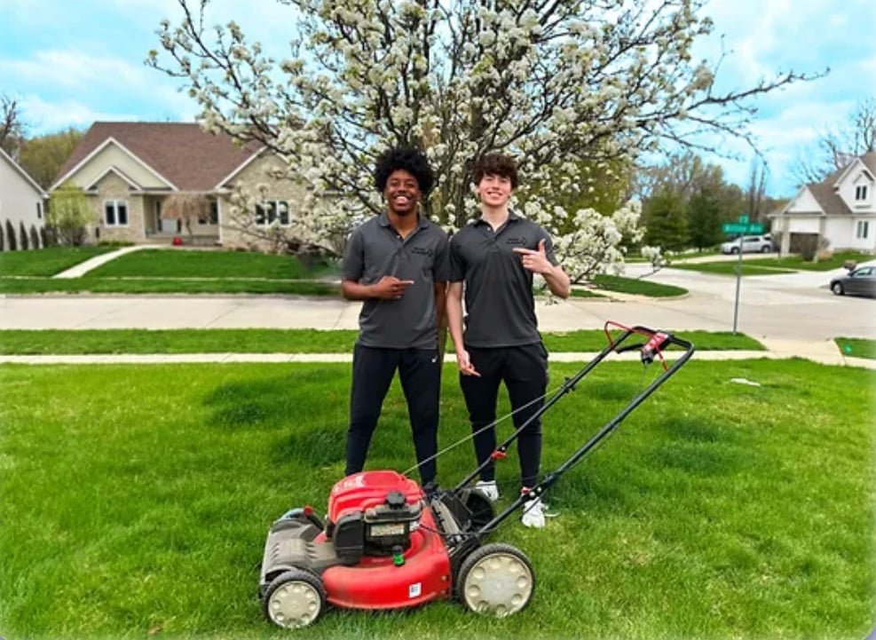 Owen, right, at 16 with a friend and a push mower during the first week of his lawn care business.